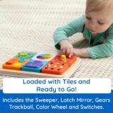 Toddler Playing with Magnetic Tiles on Fat Brain Toys Sensory Busy Board