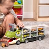 A toddler boy playing on a rug with a large T-Rex dinosaur truck carrier toy that stores multiple small dinosaur pull-back cars in side compartments.