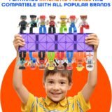 A smiling young boy holding up a row of Playmags purple magnetic tiles with colorful magnetic community figures attached to both the top and bottom, demonstrating strong magnetic connection. Text above reads "Playmags magnetic figures are compatible with all popular brands."